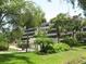 View of the building and lush green landscape at 6285 Midnight Pass Rd # 403, Sarasota, FL 34242