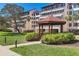 Exterior shot of the building with a gazebo and manicured landscaping at 6285 Midnight Pass Dr # 403, Sarasota, FL 34242