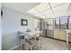 Open kitchen with stainless steel appliances, a breakfast table, and a sunlit window at 6285 Midnight Pass Dr # 403, Sarasota, FL 34242
