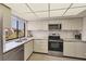 Modern kitchen with stainless steel appliances and ample counter space at 6285 Midnight Pass Rd # 403, Sarasota, FL 34242