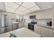 Well-lit kitchen with stainless steel appliances and convenient island counter at 6285 Midnight Pass Rd # 403, Sarasota, FL 34242