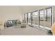 Inviting living room with a sofa, accent chair, and large sliding windows that offers natural light at 6285 Midnight Pass Rd # 403, Sarasota, FL 34242