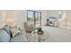 Bright living room with a comfortable sofa, accent chair, and sliding glass doors that offer lovely views and natural light at 6285 Midnight Pass Rd # 403, Sarasota, FL 34242