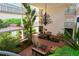 Open-air lobby features comfortable seating, a decorative chandelier, and lush landscaping, perfect for relaxation at 6285 Midnight Pass Rd # 403, Sarasota, FL 34242