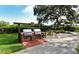 Exterior image shows stainless steel outdoor grills and a seating area at 6285 Midnight Pass Dr # 403, Sarasota, FL 34242