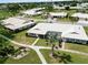 Overhead view of a home with manicured landscaping, long driveway and white tile roof at 6615 12Th Ave W W Ave, Bradenton, FL 34209