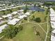Beautiful aerial view showcasing a lush community with a pond, pool, and well-maintained green spaces at 6615 12Th Ave W W Ave, Bradenton, FL 34209