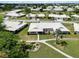 Scenic aerial shot of homes surrounded by lush landscaping and a white tile roof at 6615 12Th Ave W W Ave, Bradenton, FL 34209