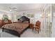 Bedroom featuring a large bed, a ceiling fan, carpet flooring, and mirrored closet doors at 6615 12Th Ave W W Ave, Bradenton, FL 34209