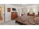 Bright bedroom with a large bed, a ceiling fan, carpet flooring, and a wooden dresser at 6615 12Th Ave W W Ave, Bradenton, FL 34209