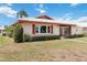 Charming home exterior featuring mature landscaping and a pathway leading to a private, screened lanai at 6615 12Th Ave W W Ave, Bradenton, FL 34209
