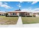 Well-maintained home exterior with manicured lawn, mature shrubbery, and a charming entryway at 6615 12Th Ave W W Ave, Bradenton, FL 34209