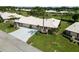 Well-maintained home with a spacious driveway, lush landscaping, and a white tile roof at 6615 12Th Ave W W Ave, Bradenton, FL 34209