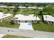 Well-kept home with a long driveway, verdant lawn, and mature palm trees at 6615 12Th Ave W W Ave, Bradenton, FL 34209