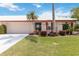 Charming single-story home with a well-manicured lawn, red shutters, and a side-entry two-car garage at 6615 12Th Ave W W Ave, Bradenton, FL 34209