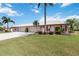 Spacious single-story home featuring a well-manicured lawn and a driveway leading to an attached garage at 6615 12Th Ave W W Ave, Bradenton, FL 34209