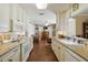 Bright kitchen with white cabinets that opens to a living room area at 6615 12Th Ave W W Ave, Bradenton, FL 34209