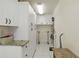 Bright laundry room featuring ample white cabinets and a countertop for folding clothes at 6615 12Th Ave W W Ave, Bradenton, FL 34209