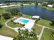 Scenic aerial view of a pool and community center overlooking a beautiful lake at 6615 12Th Ave W W Ave, Bradenton, FL 34209