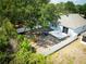 Aerial view of the backyard with patio, fenced yard, mature tree, and play set at 6711 Cambridge Park Dr, Apollo Beach, FL 33572