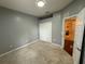 Bedroom featuring carpeted floors, a double door closet, and a gray paint scheme at 6711 Cambridge Park Dr, Apollo Beach, FL 33572