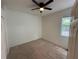 Carpeted bedroom featuring a ceiling fan, double door closet, and natural light at 6711 Cambridge Park Dr, Apollo Beach, FL 33572