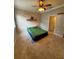 Carpeted bedroom featuring wood-look accent wall, ceiling fan, and natural light at 6711 Cambridge Park Dr, Apollo Beach, FL 33572