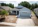 Charming single-Gathering home with a well-maintained lawn and attached two-car garage at 6711 Cambridge Park Dr, Apollo Beach, FL 33572