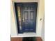 Stylish navy front door with sidelight and secure smart lock at 6711 Cambridge Park Dr, Apollo Beach, FL 33572