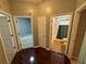 Hallway with access to bedroom, bathroom, and closet, featuring hardwood floors at 6711 Cambridge Park Dr, Apollo Beach, FL 33572