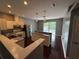 Modern kitchen with stainless steel appliances and a breakfast bar at 6711 Cambridge Park Dr, Apollo Beach, FL 33572