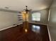 Bright living room with hardwood floors and a modern ceiling fan at 6711 Cambridge Park Dr, Apollo Beach, FL 33572