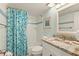Well-lit bathroom featuring a shower-tub combo, stylish tile accents, and granite vanity at 7100 Gulf Dr # 114, Holmes Beach, FL 34217