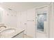Clean and bright bathroom featuring a granite countertop vanity, and a beautifully tiled glass door shower at 7100 Gulf Dr # 114, Holmes Beach, FL 34217
