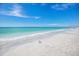 Beach view with white sand, surf and blue skies at 7100 Gulf Dr # 114, Holmes Beach, FL 34217