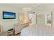 Serene bedroom features a comfortable bed, dresser, and mounted TV, offering a peaceful retreat for relaxation at 7100 Gulf Dr # 114, Holmes Beach, FL 34217