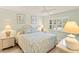 Comfortable bedroom featuring a queen-sized bed, ample natural light, and tasteful decor for a relaxing retreat at 7100 Gulf Dr # 114, Holmes Beach, FL 34217