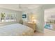 Calm bedroom featuring a comfortable bed, dresser, TV, and ample natural light, creating a peaceful retreat at 7100 Gulf Dr # 114, Holmes Beach, FL 34217