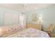 Bright bedroom with twin beds, ceiling fan, and ample closet space for comfortable coastal living at 7100 Gulf Dr # 114, Holmes Beach, FL 34217