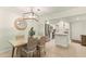 Dining area with a glass-top table, wicker chairs, and adjacent modern kitchen at 7100 Gulf Dr # 114, Holmes Beach, FL 34217
