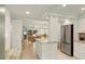 Open-concept kitchen and living area with island, stainless steel appliances, and tile flooring at 7100 Gulf Dr # 114, Holmes Beach, FL 34217
