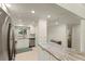 Kitchen with stainless steel refrigerator and granite countertops and tile floors at 7100 Gulf Dr # 114, Holmes Beach, FL 34217