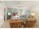 Inviting living room with comfortable seating, ceiling fan, and sliding glass doors to the outside area at 7100 Gulf Dr # 114, Holmes Beach, FL 34217