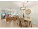 View of the living room and dining area with wicker furniture at 7100 Gulf Dr # 114, Holmes Beach, FL 34217