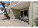 View of the patio with bench and table with chairs, with a peek of the beachfront beyond at 7100 Gulf Dr # 114, Holmes Beach, FL 34217