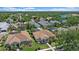 Scenic aerial view of residential properties, featuring well-manicured lawns, pools, and mature trees at 750 Anna Hope Ln, Osprey, FL 34229