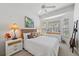 Bright bedroom with a ceiling fan, a window seat, and light wicker furniture at 750 Anna Hope Ln, Osprey, FL 34229