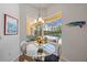 Breakfast nook with glass table and backyard views of screened-in patio and pool at 750 Anna Hope Ln, Osprey, FL 34229