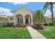 Charming single-story home with a well-manicured lawn, beautiful landscaping, and welcoming covered front porch at 750 Anna Hope Ln, Osprey, FL 34229