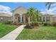Inviting single-story home with lush landscaping, a well-manicured lawn, and charming covered entryway at 750 Anna Hope Ln, Osprey, FL 34229